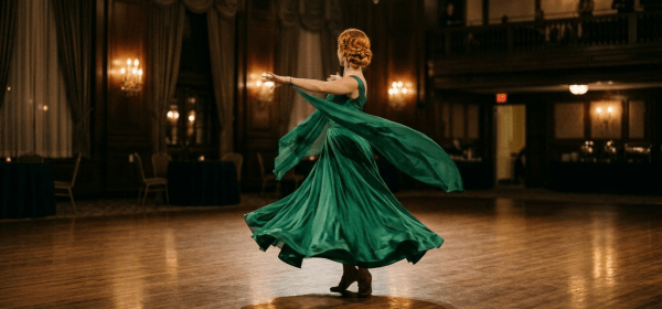 Woman dancing elegantly in a green flowing dress in a grand ballroom